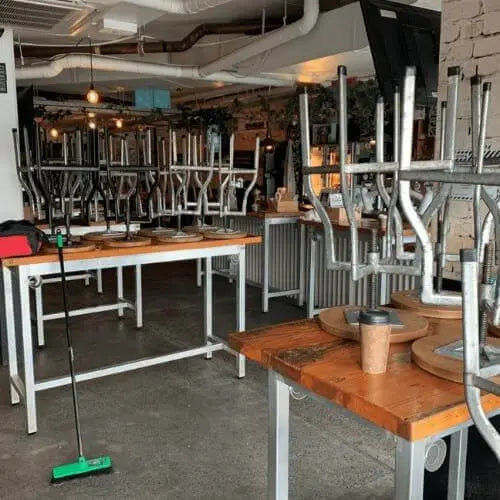 Overview of all the furniture in the bar flipped upside down with their new silicone chair leg floor protectors NEW
