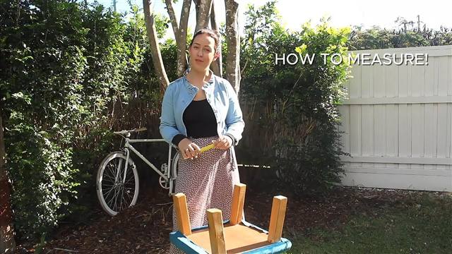 Courtney demonstrating how to measure a chair leg